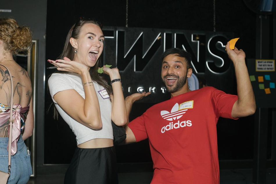 Two attendees laughing mid-conversation at a Sweaty Friends event