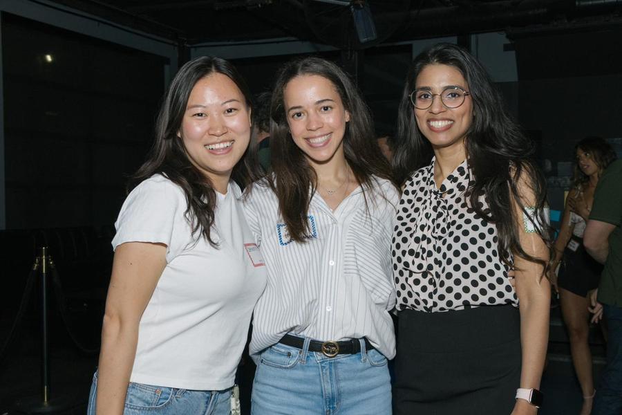 Three attendees smiling together